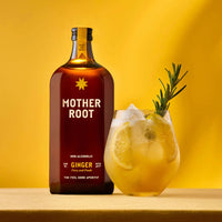 Brown bottle labeled "Mother Root Ginger" beside a glass of ice-filled yellow drink with lemon slices and rosemary on a yellow background.