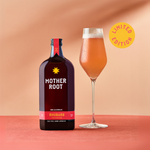 Mother Root rhubarb non-alcoholic drink bottle and glass on a peach background