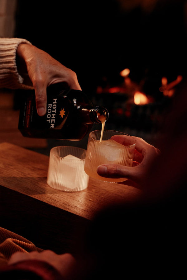 Pouring Bonfire Ginger into a tumbler of ice by the fire