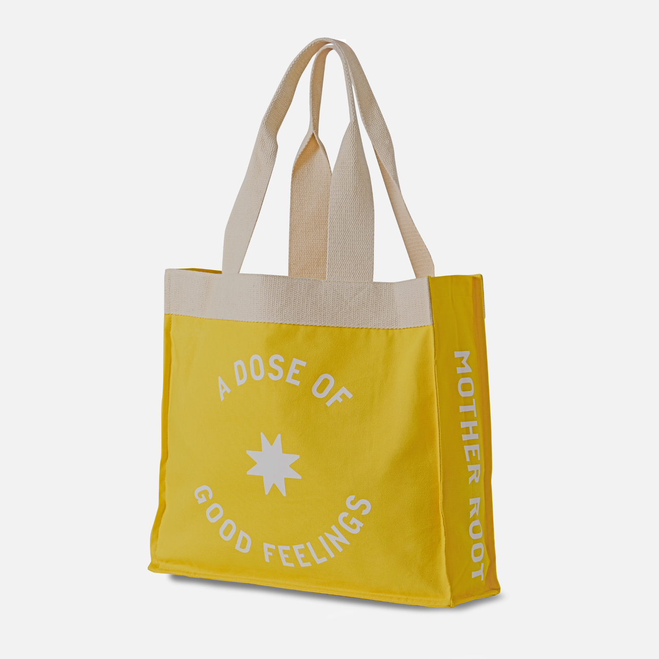 Yellow Mother Root Tote Bag with beige handles, side pockets, and white text; celebrates a sustainable initiative.